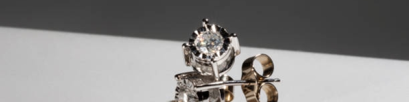 Diamond earrings. Big diamond earrings, large solitaire earrings on white background. Four prong, four claw diamond earrings with posts and backs. Round brilliant cut diamonds.